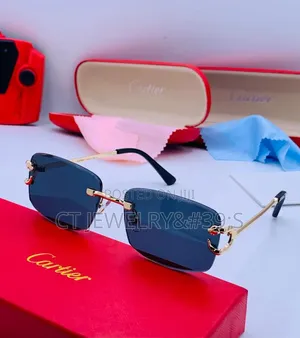Cartier Sunglasses Featuring a Gold Frame and Blue Tinted Lenses.