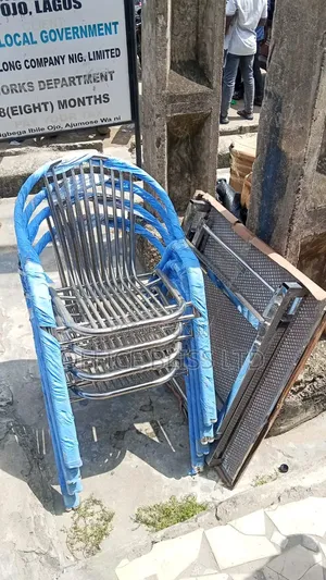 A Set of Outdoor Stainless Folding Table 4 Stackable Chairs