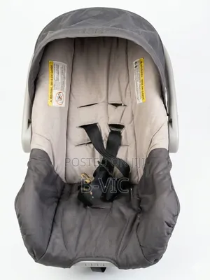 Grey and Beige Baby Trend Infant Car Seat.