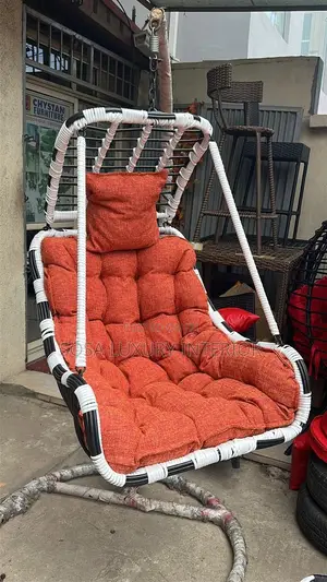 Hanging Wicker Swing Chair With Orange Cushions