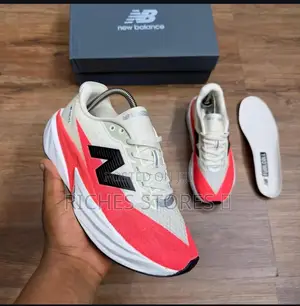 New Balance Fuelcell Rebel Running Shoes in a White and Coral Colorway