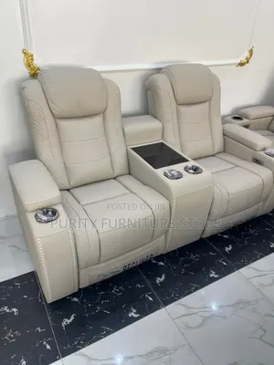These Are White Leather Electric Recliner Sofas With a Center Console.