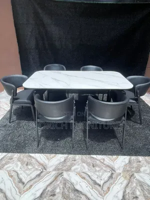 **Title:** White Marble Dining Set – 6-Seater With All-Black Barrel