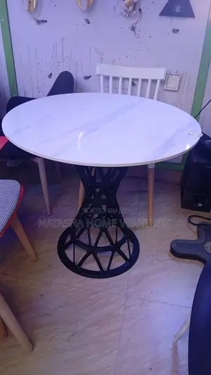 Round Marble-Top Dining Table With Geometric Black Metal Pedestal Base