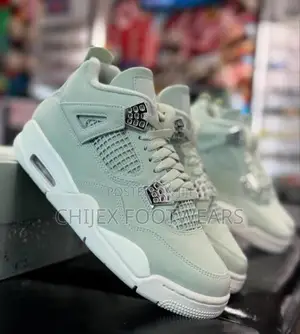 Unisex Air Jordan 4 Retro" Sneakers Feature a Green Colorway