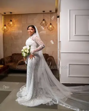 White Sequin-Encrusted Mermaid Bridal Gown With Illusion Sleeves.