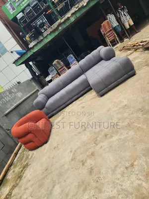 Executive Grey Upholstery Padded Sofa Chair With Its Single Seater.