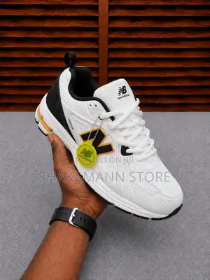 New Balance 1906r Feature White Mesh Upper Gold and Black Accents.