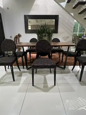 Eight Caligaris Dining Chairs and a Walnut Effect Dining Table
