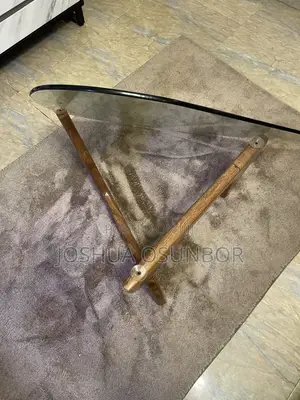 A Glass-Top Table on an Interlocking Two-Piece Wooden Base