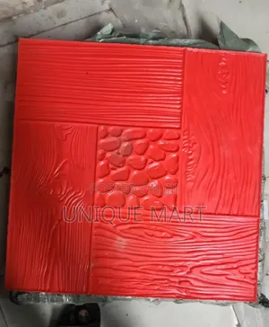 Red Concrete Stamp Mould Used to Create Textured Patterns on Pavement