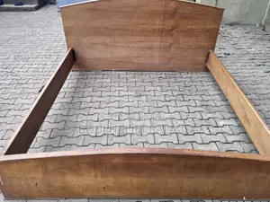 Neatly Used Brown Wooden Bed Frame