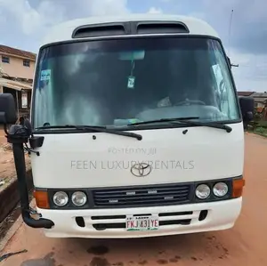 White Toyota Coaster Minibus for Rent | Minibus for Hire