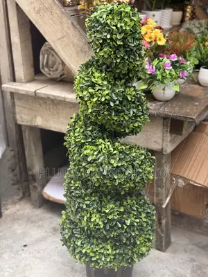 This Artificial Topiary Tree Features Multiple Tiered Green Ball-Shape