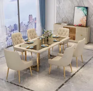 6-Seater Cream Glass-Top Dining Set–Gold Trestle Base Tufted Armchairs