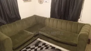 A Fairly Used Dark Green 5 Seater Couch