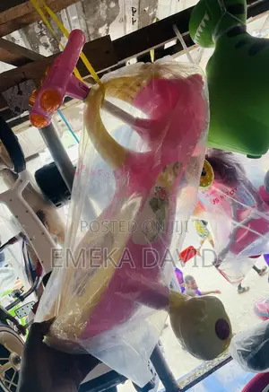This Pink and Yellow Ride-on Toy Is a Children’s Twist Car. 