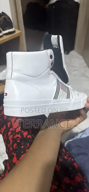 A Tommy Hilfiger Sneaker With Red and White Stripes