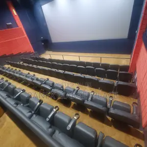 Furnished Banex Cinema Hall With Black Cushioned Chairs
