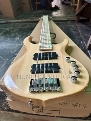 String Electric Bass Guitar With a Natural Wood Finish