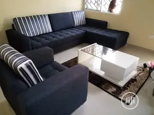 L-Shaped Fabric Sofa With a Single and Center Table