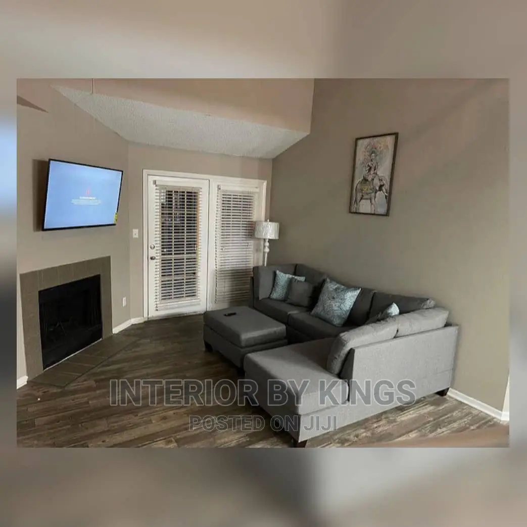 L-Shaped Fabric Sofa With an Ottoman.