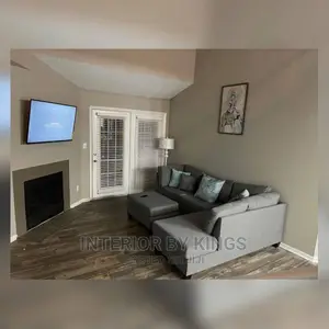 L-Shaped Fabric Sofa With an Ottoman.