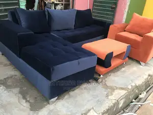 L-Shaped Fabric Sofa With One Single Ad a Center Table