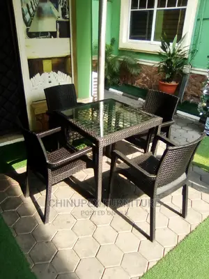 A Set of Plastic Cane Chairs With Glass Top Table